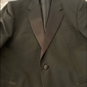 Men’s black wool tuxedo suit jacket and pants.